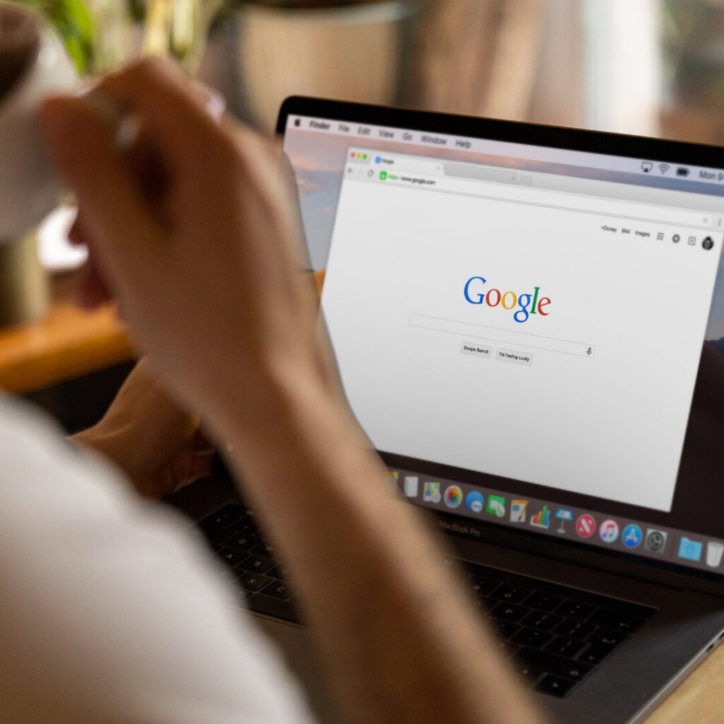 Person looking over a Google search engine looking up SEO.