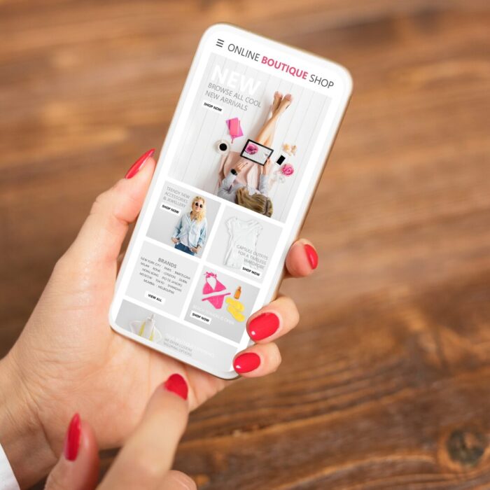 Person holding a cellphone scrolling through a business website.