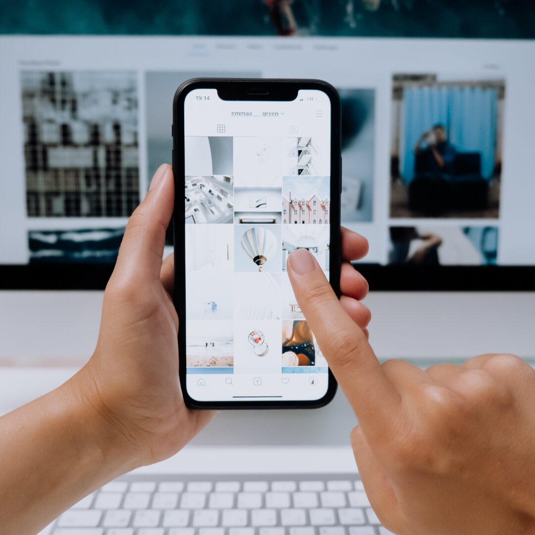 phone in front of a desktop browser with a finger scrolling through the phone.
