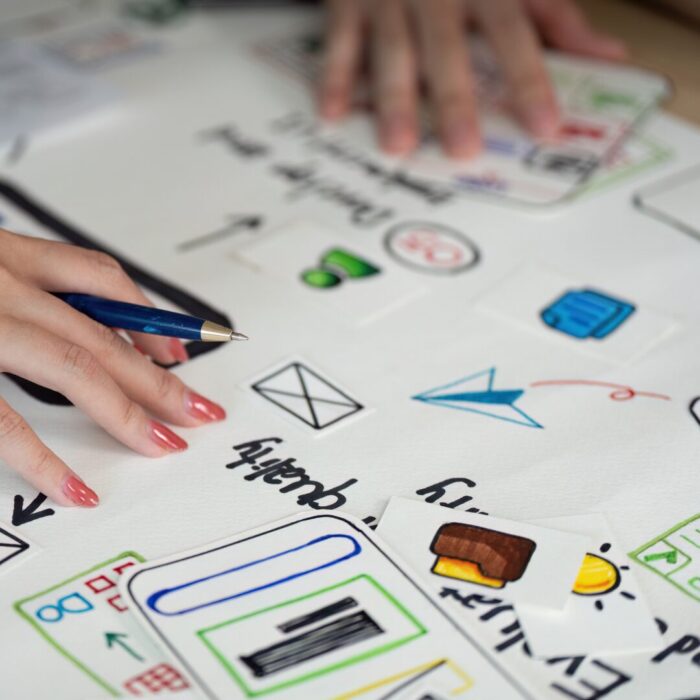 Two people working over a UX/UP design for a website.