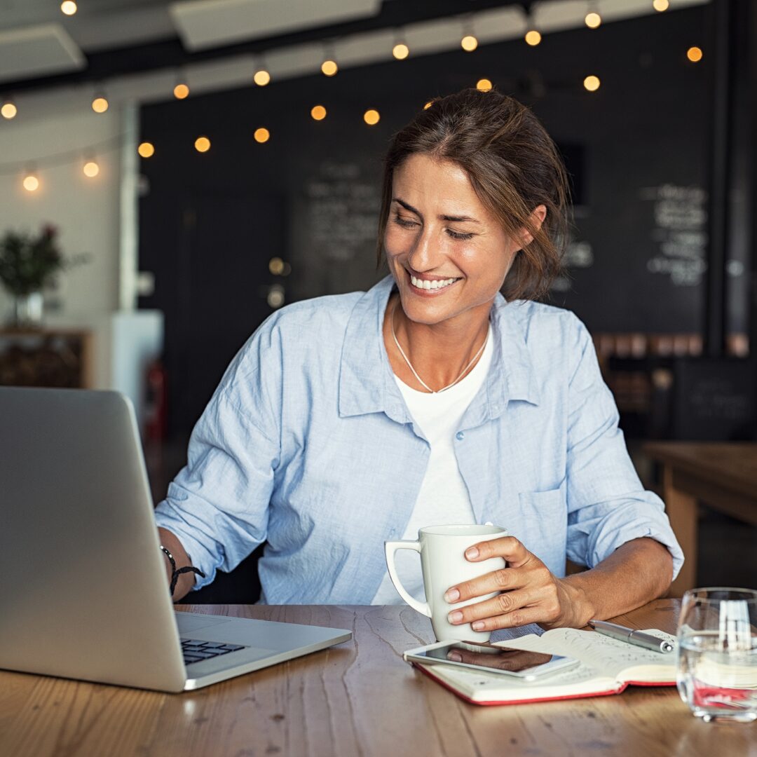 Small business owner looking for a web hosting platform on their laptop.