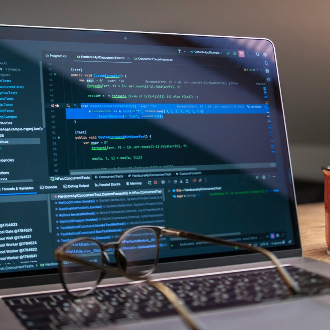 Laptop screen showing AI-generated code suggestions, e.g., GitHub Copilot or AI code prompts.