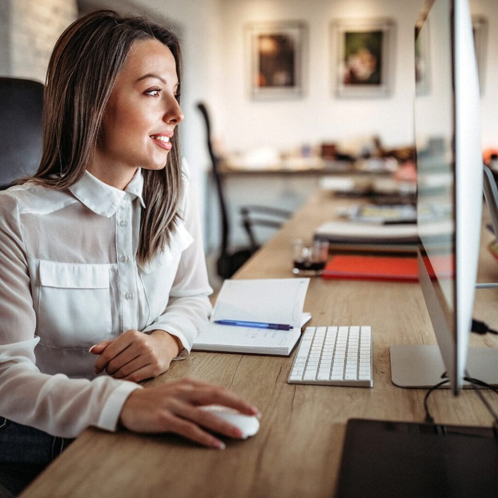 Business owner looking at domain names for their business on a computer.